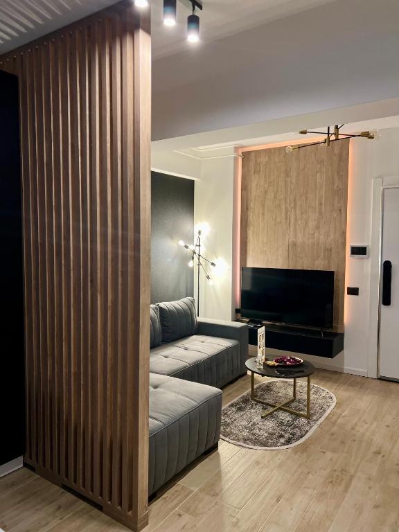a living room with a couch and a table at Elite Summer Suite in Năvodari