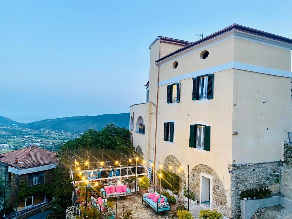 a building with a table and chairs in front of it at Palazzo Gentilcore in Castellabate