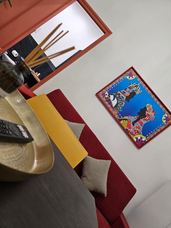 a room with a bed and a picture on the wall at Lu Màri case vacanze in Balestrate
