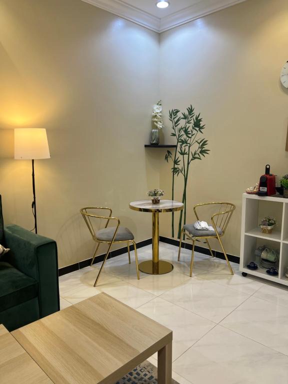 a living room with a table and chairs at ليلك lilac in Abha