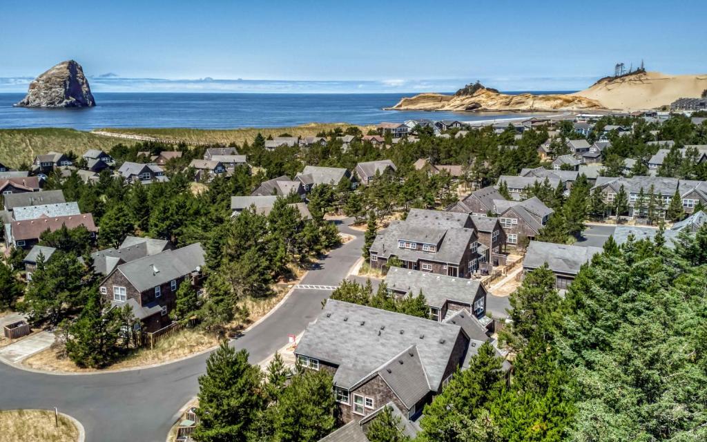 an aerial view of a village with houses and the ocean at A Mermaids Dream - Meredith Lodging in Pacific City