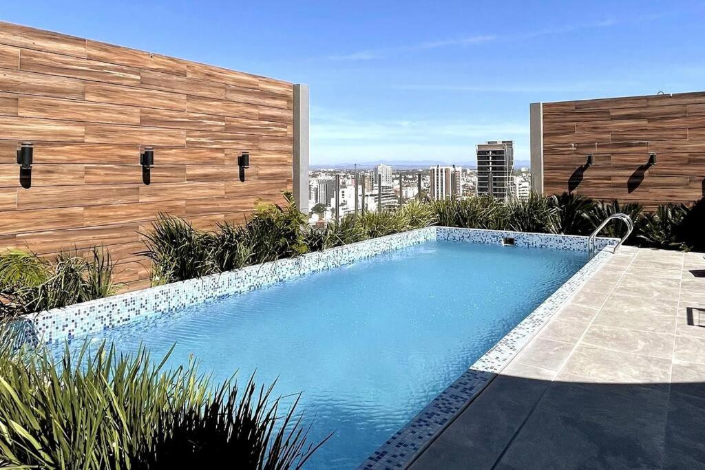 a swimming pool sitting on top of a building at Departamento 2 ambientes full amenities + Cochera in Santa Cruz de la Sierra