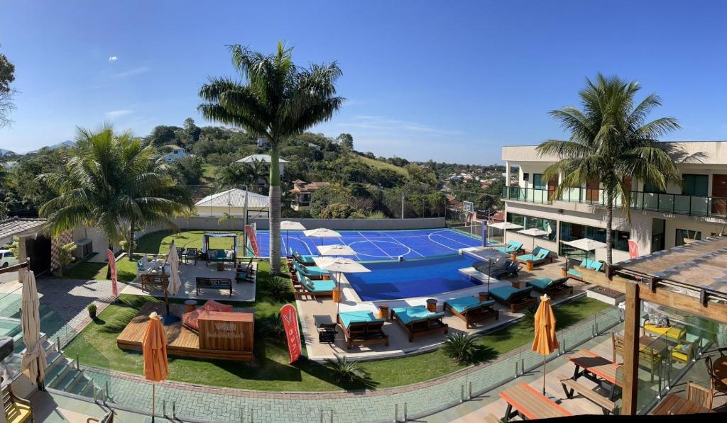 an aerial view of a pool and a tennis court at VIVER Pousada Club & Restaurante in Saquarema