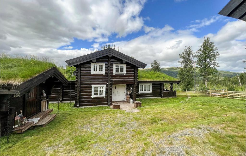 a log cabin with a grass roof at 4 Bedroom Amazing Home In Nord-torpa in Nord Torpa