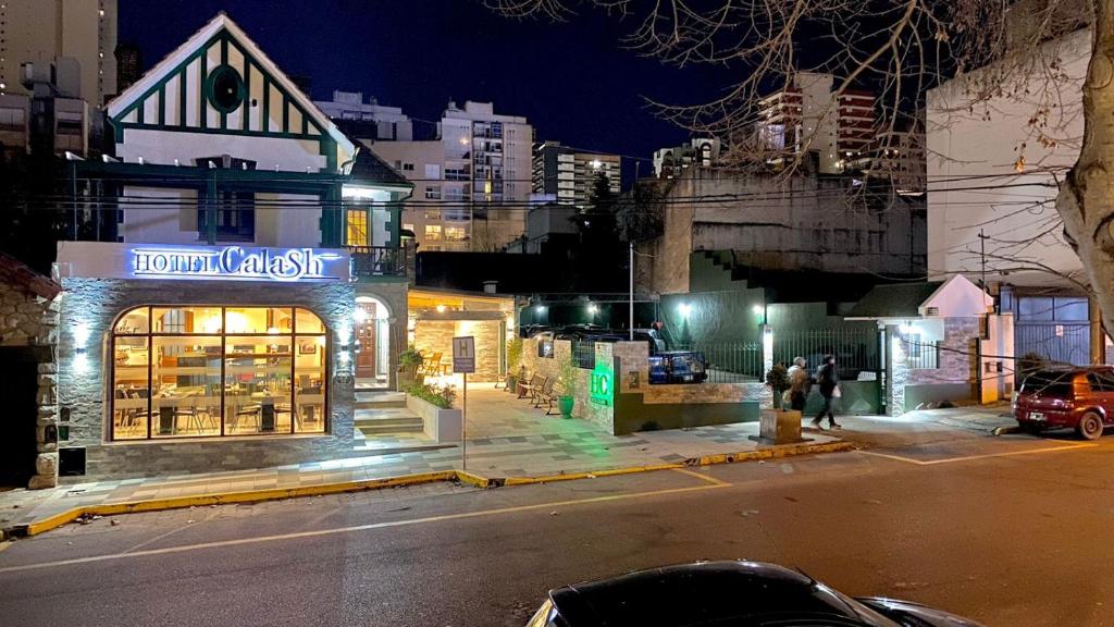 a store on the side of a street at night at Hotel Boutique Calash in Mar del Plata