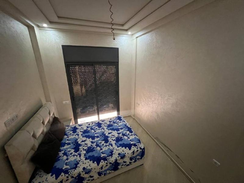 מיטה או מיטות בחדר ב-سيدي رحال الشاطئ