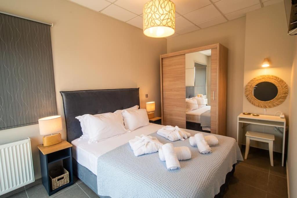 a bedroom with a bed with towels on it at Luxury Apartment in Chalkida #1 in Chalkida