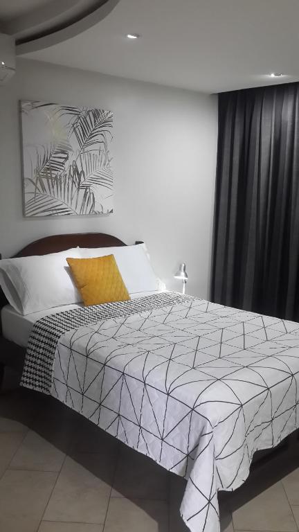 a bedroom with a bed with a black and white comforter at Room at the Sky in Panama City