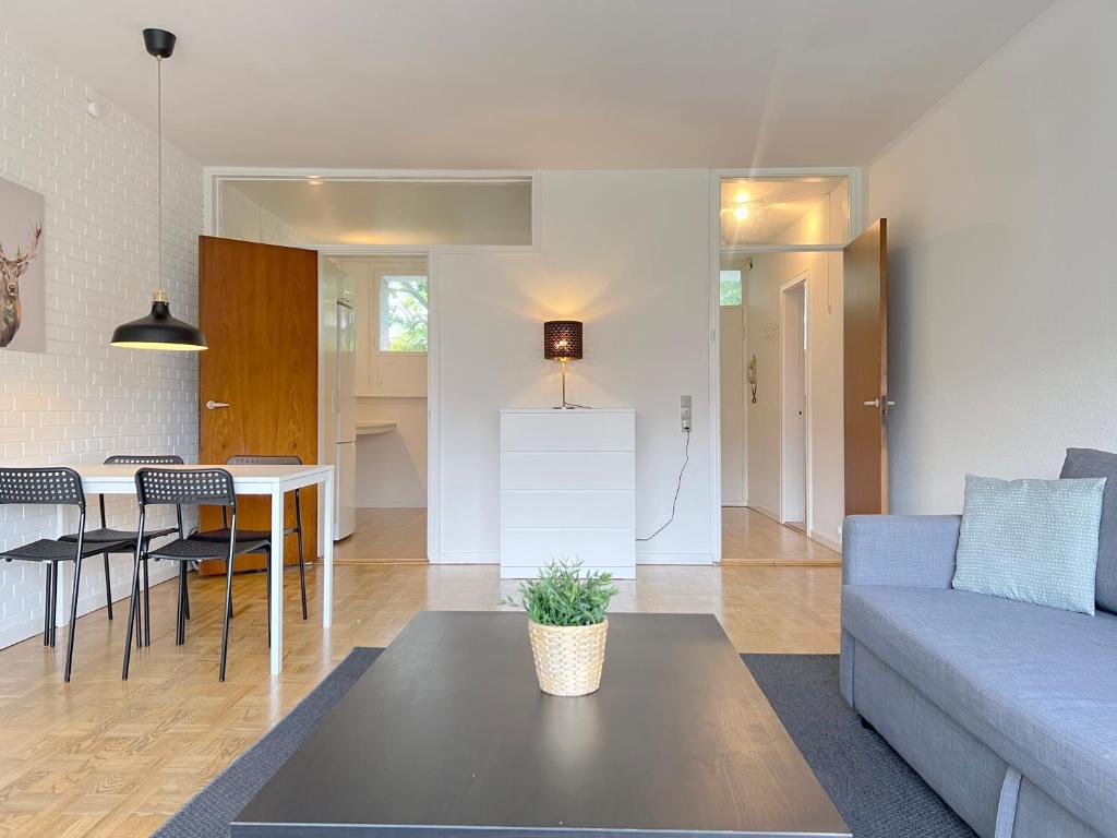 a living room with a couch and a table at One Bedroom Apartment In Valby, Langagervej 66, in Copenhagen