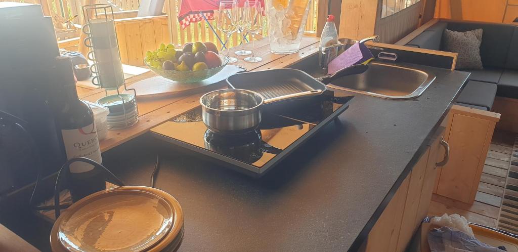 a kitchen counter with a stove with a pot on it at Larah Land 4 Star Glamping Yala Lodge plus kids lodge in Šimuni