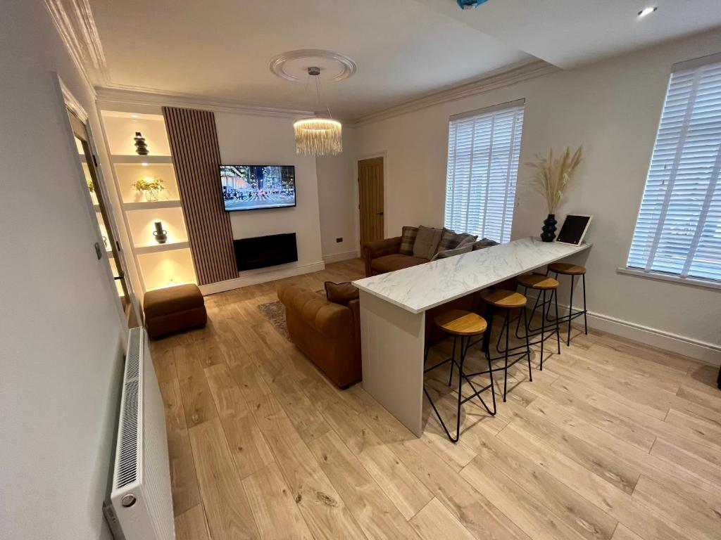 a kitchen and living room with a bar and a couch at Coastal Apartments No 2 in Seaham
