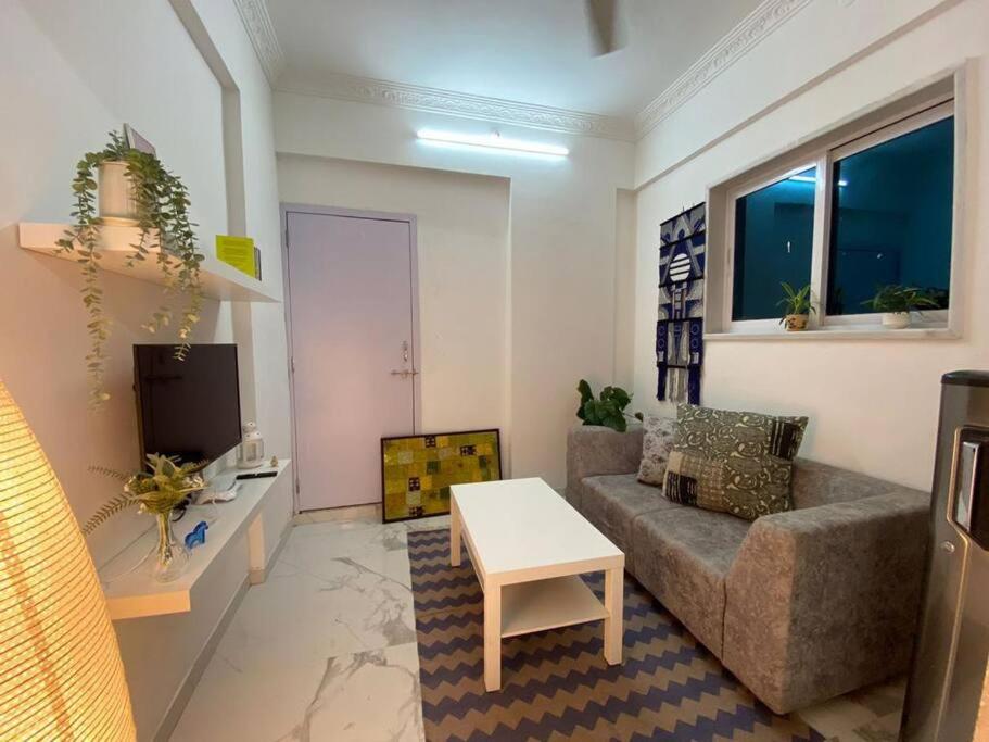 a living room with a couch and a table at Angel Views 601, Chapel Road, Bandra West by Connekt Homes in Mumbai