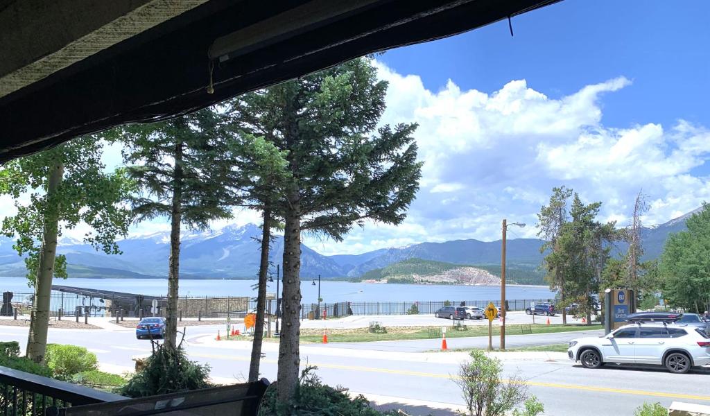a view of a street with a lake and mountains at Mountain luxury on Lake Dillon, close to all the best ski resorts in Colorado! in Dillon