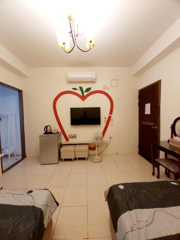 a living room with a heart painted on the wall at Happy Heart B&amp;B in Taitung City