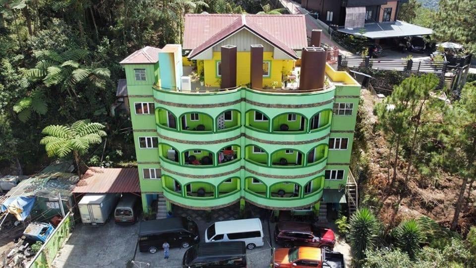 een groen gebouw met een huis erop bij Unit Three Transient Home in Baguio