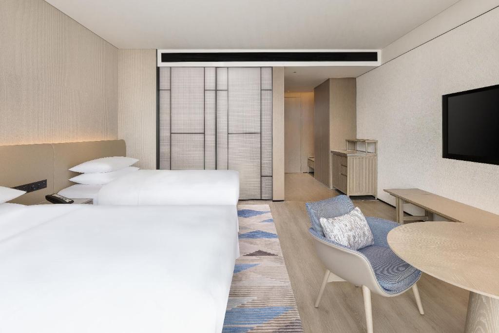 Postel nebo postele na pokoji v ubytování Sheraton Beihai Resort
