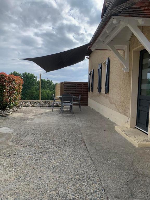 - une terrasse avec un banc et un auvent dans un bâtiment dans l'établissement L'hoste dou Lacq, à Lacq