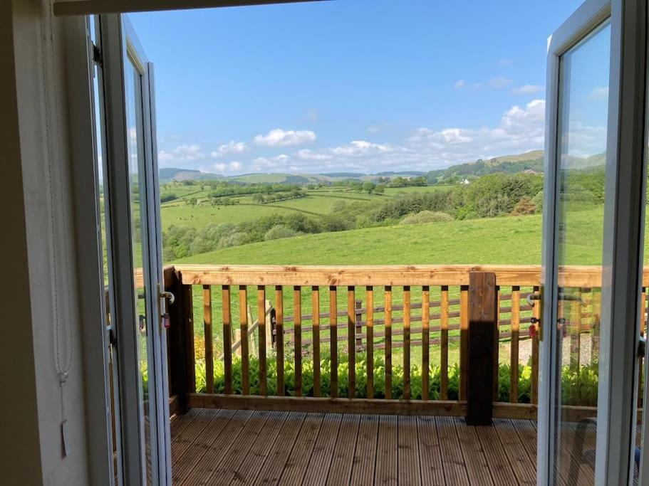 a balcony with a view of a green field at Welsh wonderland in Builth Wells