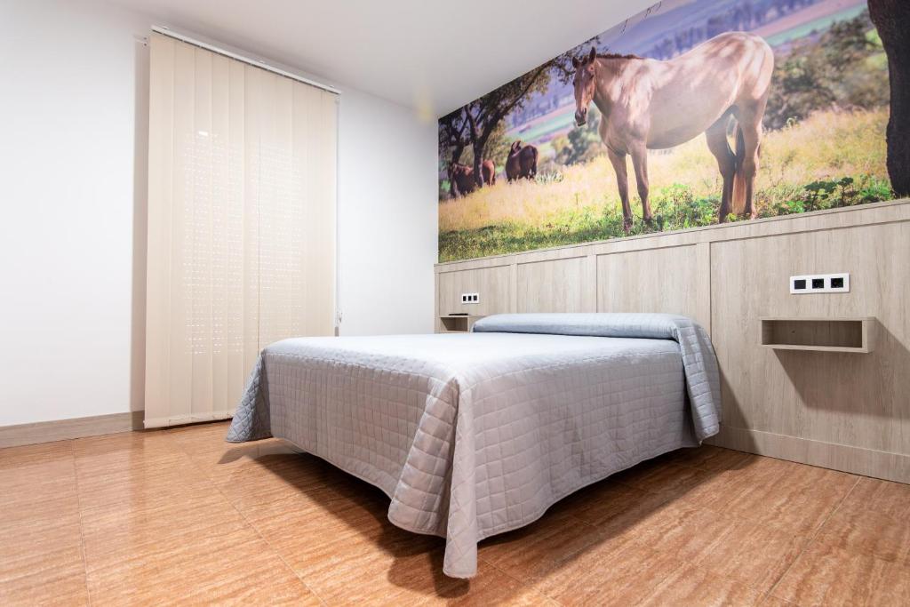 Postel nebo postele na pokoji v ubytování Hostal Viñuela