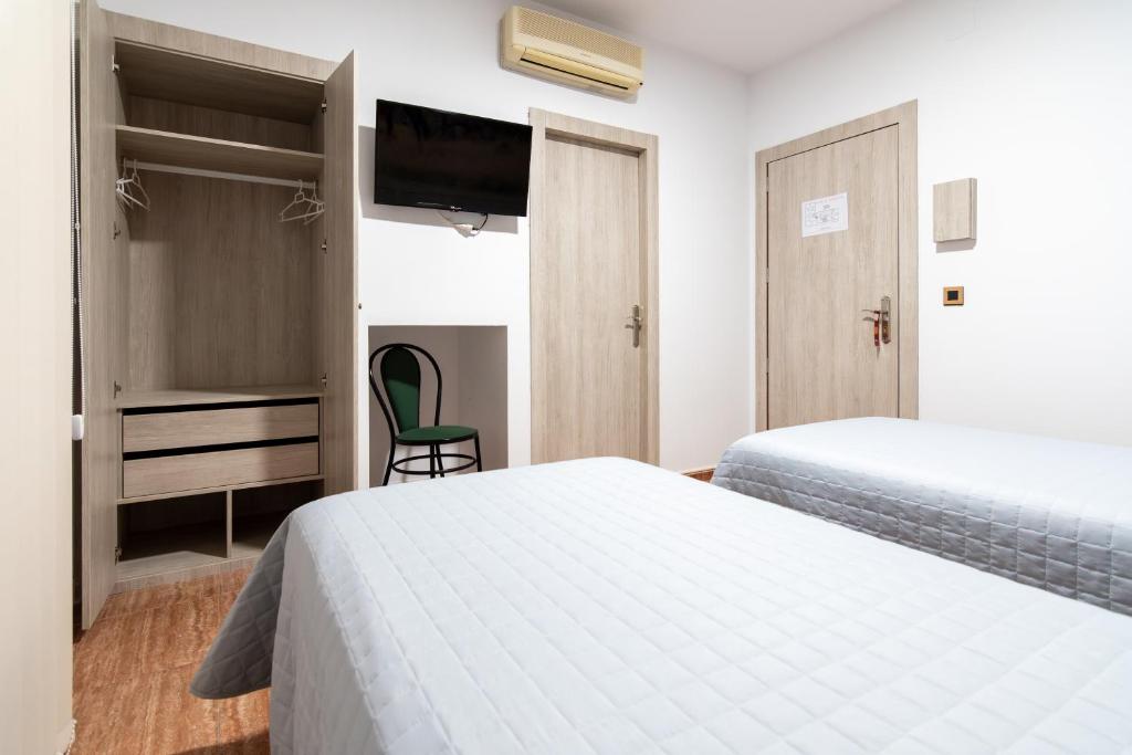 Postel nebo postele na pokoji v ubytování Hostal Viñuela