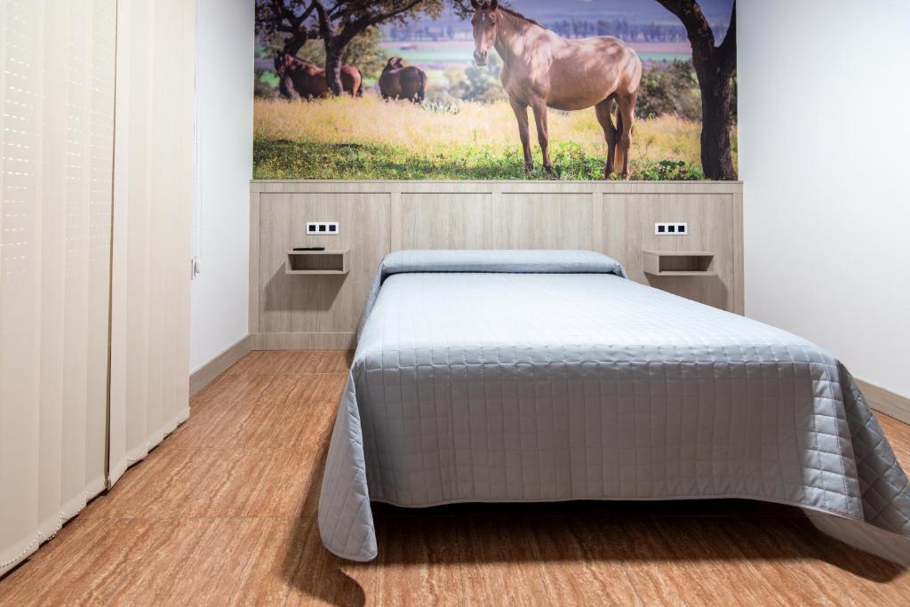 Postel nebo postele na pokoji v ubytování Hostal Viñuela