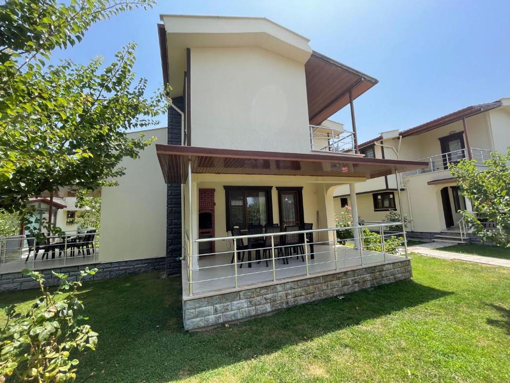 a house with a balcony in the yard at Huge Villa 300 meters to sea and near to Ida mount in Burhaniye