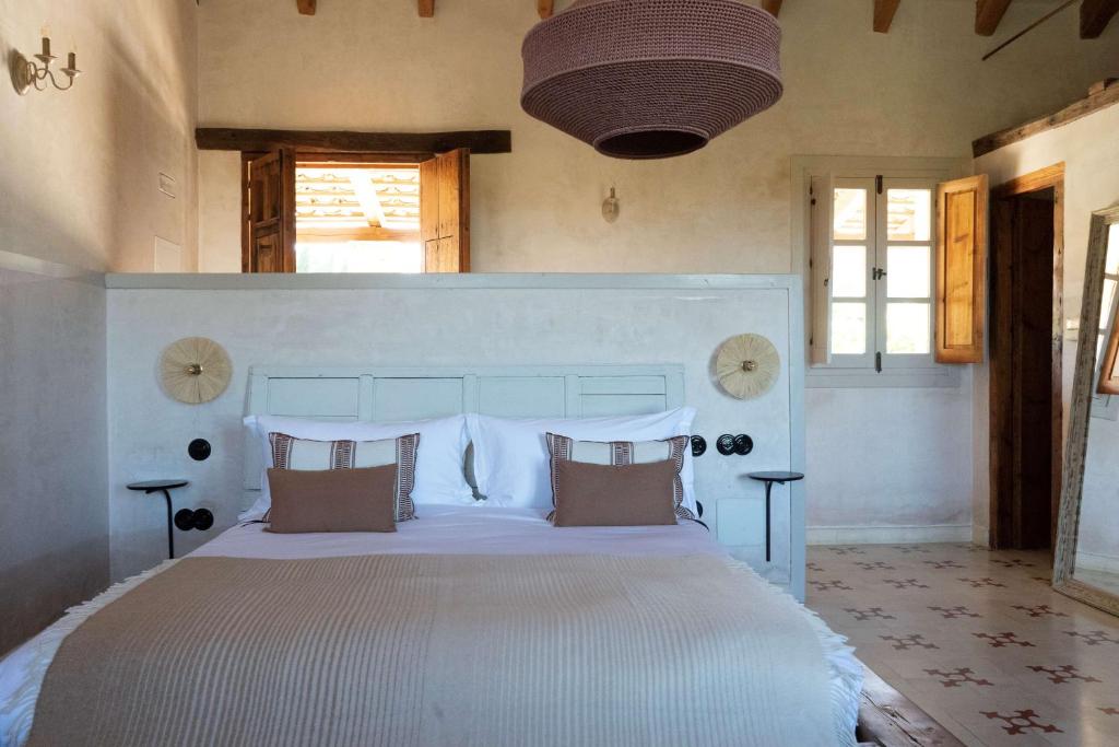 a bedroom with a large white bed with pillows at Casa La Siesta in Vejer de la Frontera