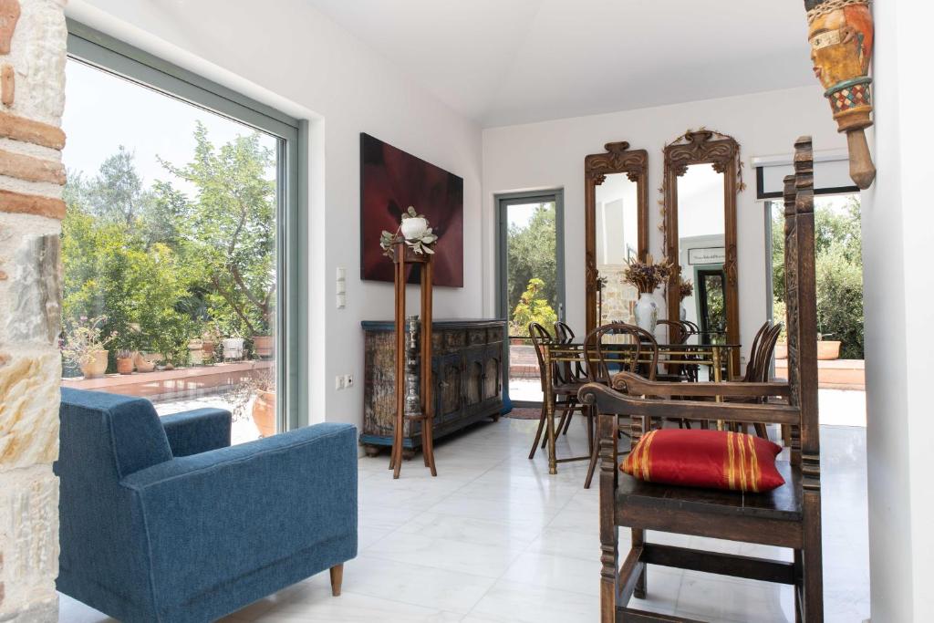 a living room with a blue couch and a blue chair at Kastelokampos Art House in Patra