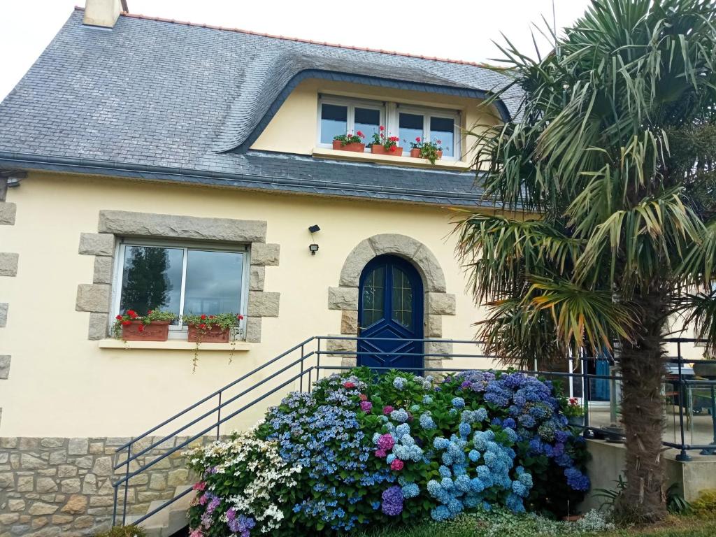 a house with flowers in front of it at LA PETITE MEUNIERE 