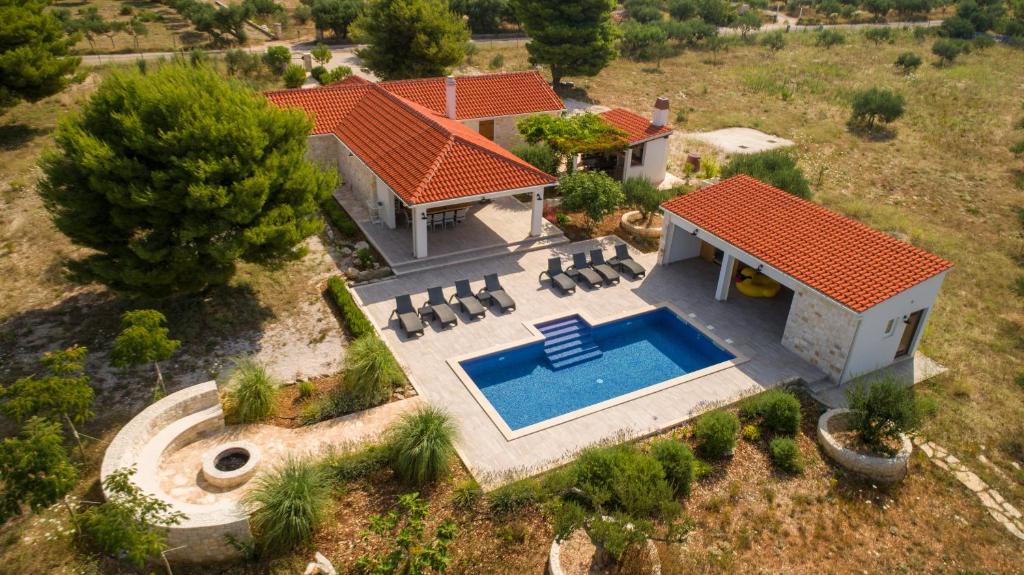 an aerial view of a house with a swimming pool at Luxury Villa Nature with heated private pool, sauna & fire pit in Milna