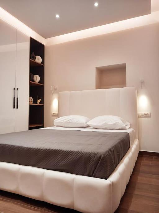 a bedroom with a large white bed in a room at Carpe Diem Suite in Liapades