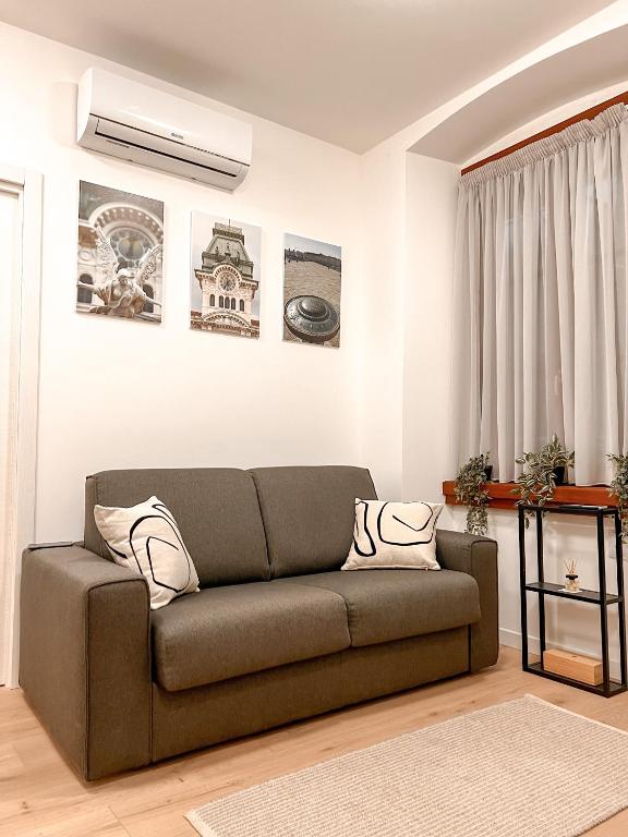 a living room with a brown couch in a room at App Borsa Trieste in Trieste