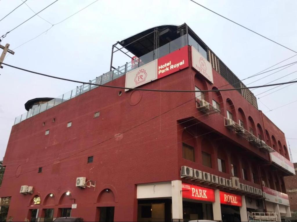 a red building with a balcony on top of it at Hotel Park Royal in Panchkula