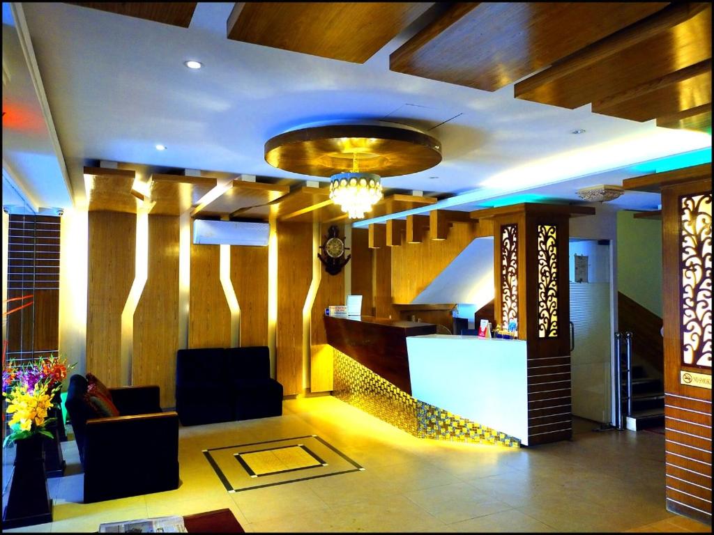 a lobby with chairs and a bar in a building at Shahjadi Resort in Cox's Bazar