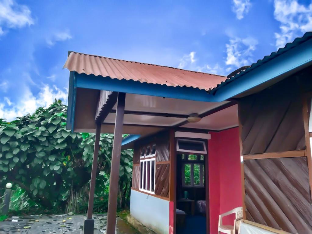 a small house with a red and blue facade at The Himalayan Resort in Ravangla