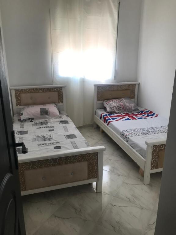 Giường trong phòng chung tại Appartement Vue sur mer Al Hoceima