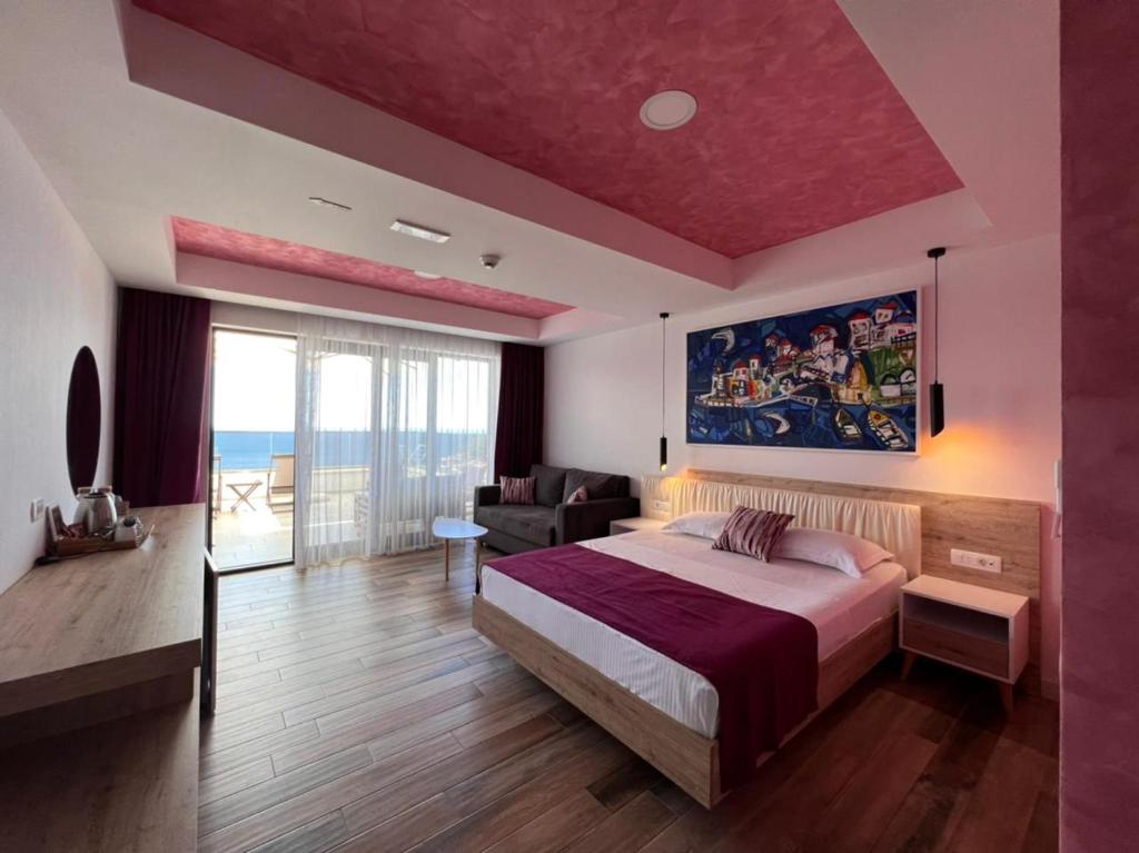 a bedroom with a large bed with a red ceiling at Maghrib in Ulcinj