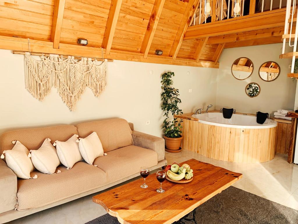 a living room with a couch and a bath tub at Usula Bungalov in Rize