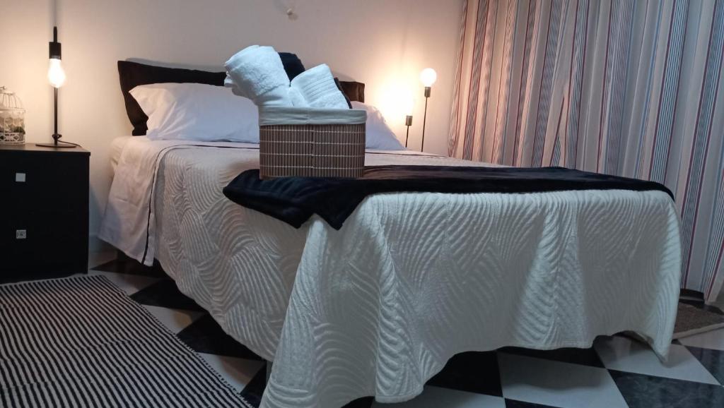 a bedroom with a bed with white sheets and pillows at Zawaiaroom in Lagos