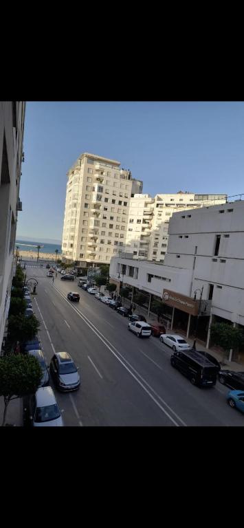 a view of a city street with buildings and cars at Apparemment tanger enface hôtel el oumnia puerto in Tangier