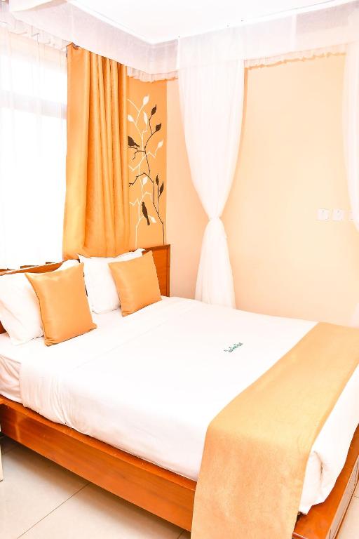 Postel nebo postele na pokoji v ubytování Divine Homes Resort Kisumu