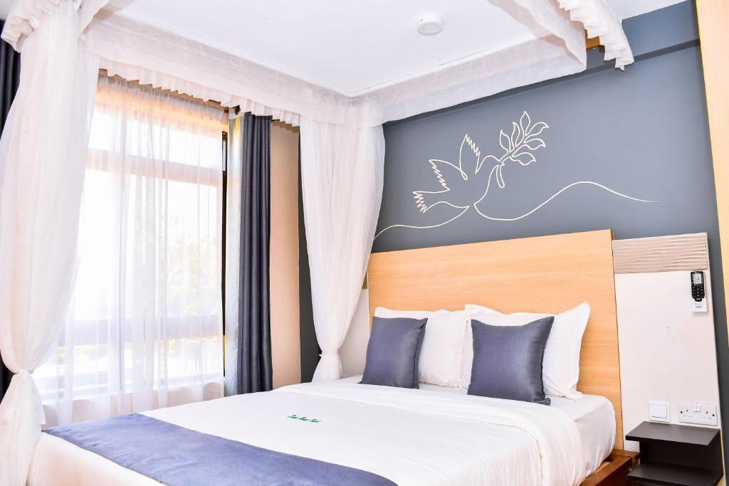 Postel nebo postele na pokoji v ubytování Divine Homes Resort Kisumu