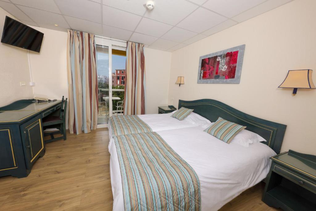 Postel nebo postele na pokoji v ubytování Hotel Saint Christophe