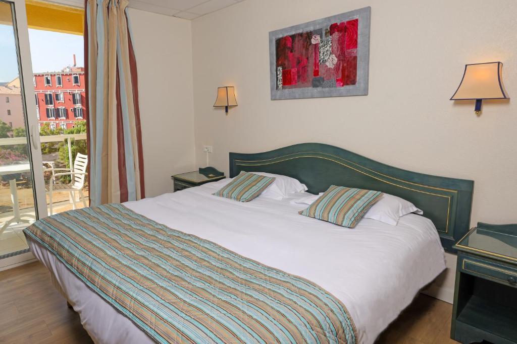 Postel nebo postele na pokoji v ubytování Hotel Saint Christophe