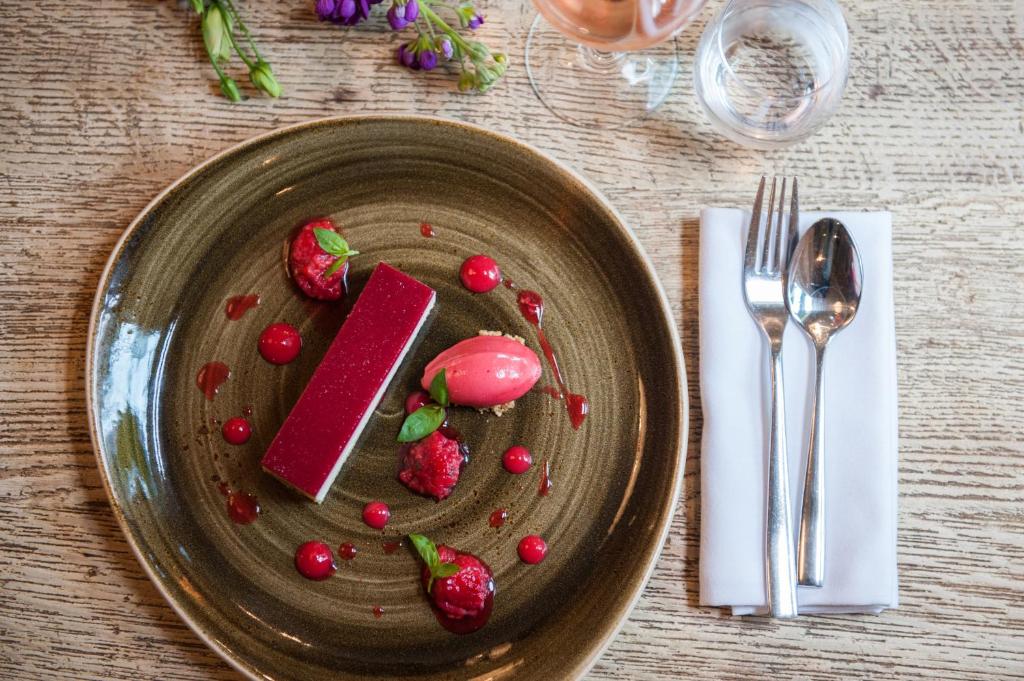 a plate of food with strawberries on a table at The Canford in Poole
