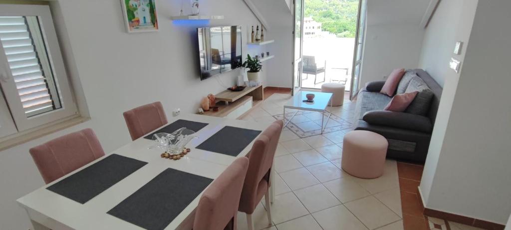a living room with a table and a couch at RITA - Charming 2-Bedroom Apartment with sea view, Slano in Slano