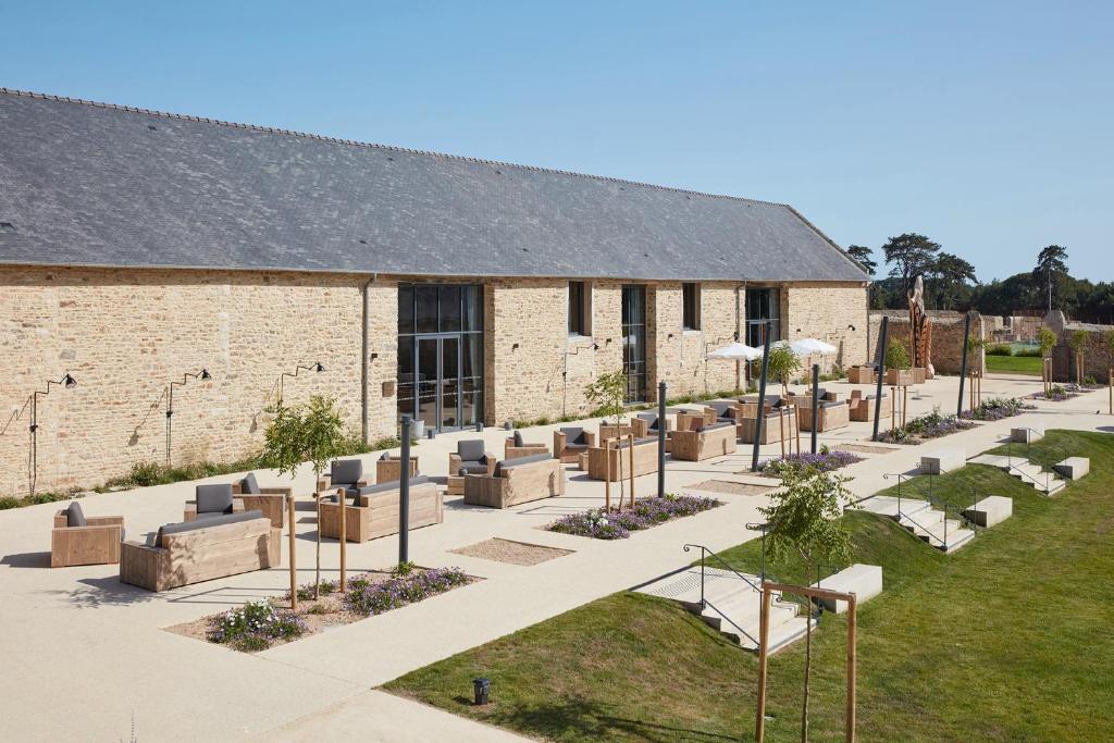 a building with a bunch of chairs in front of it at DOMAINE LE MEZO in Ploeren