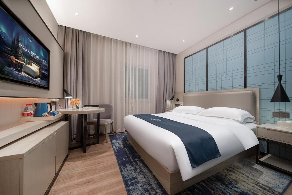 Postel nebo postele na pokoji v ubytování Echarm International Hotel Canton Tower Pazhou Convention and Exhibition Center Lujiang Subway Metro Branch - Free Shuttle Bus to Canton Fair Complex During Canton Fair Period