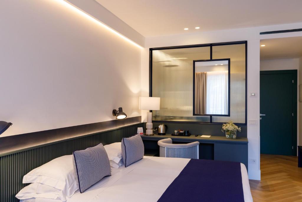 Postel nebo postele na pokoji v ubytování Grand Hotel Cesare Augusto