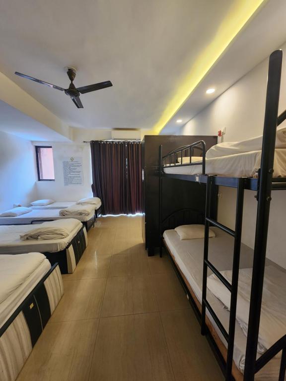 All Seasons Guest House I Rooms & Dorms - Bed In Male Dormitory Room